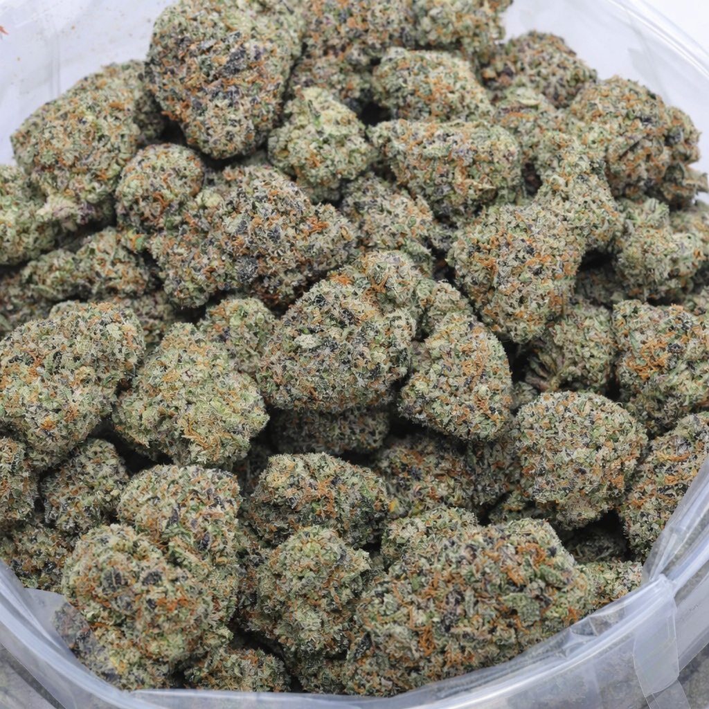 Macro close-up of Tropicana Cherry strain Nelson Farm Craft AAAA cannabis flower with frosty trichomes